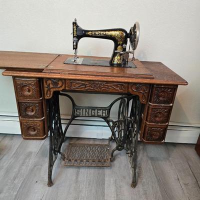 antique Singer treadle sewing machine with a wooden cabinet Complete with accessories and original manual