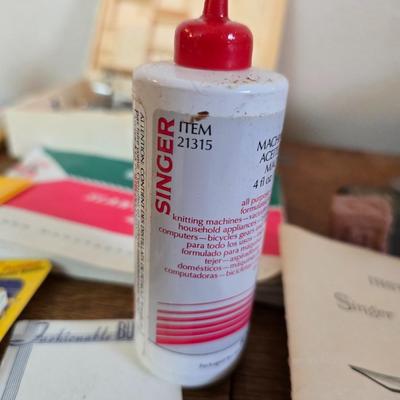 antique Singer treadle sewing machine with a wooden cabinet Complete with accessories and original manual