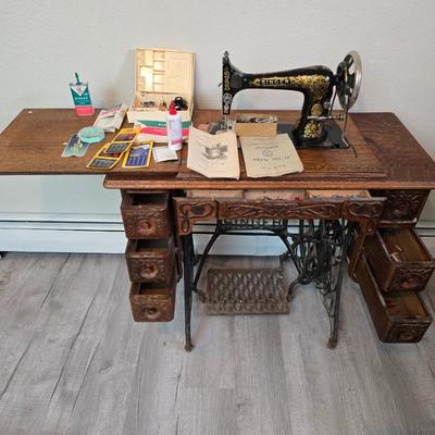 antique Singer treadle sewing machine with a wooden cabinet Complete with accessories and original manual