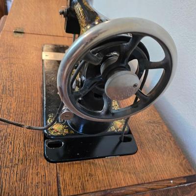 antique Singer treadle sewing machine with a wooden cabinet Complete with accessories and original manual