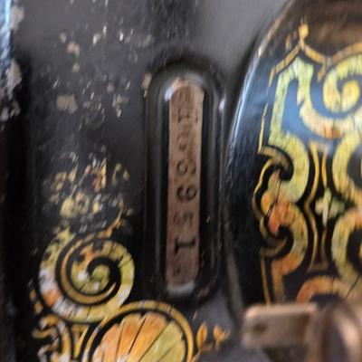 antique Singer treadle sewing machine with a wooden cabinet Complete with accessories and original manual