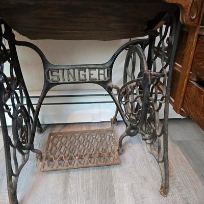 antique Singer treadle sewing machine with a wooden cabinet Complete with accessories and original manual