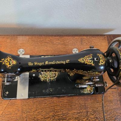 antique Singer treadle sewing machine with a wooden cabinet Complete with accessories and original manual