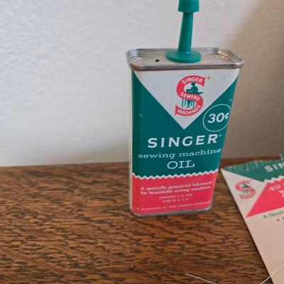 antique Singer treadle sewing machine with a wooden cabinet Complete with accessories and original manual