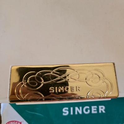 antique Singer treadle sewing machine with a wooden cabinet Complete with accessories and original manual