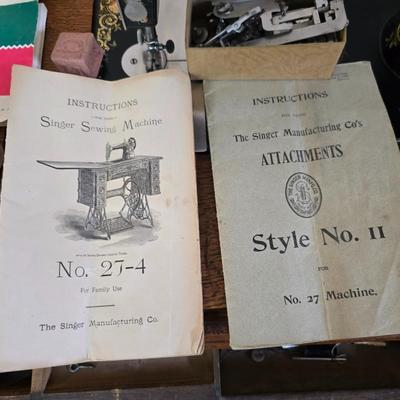 antique Singer treadle sewing machine with a wooden cabinet Complete with accessories and original manual