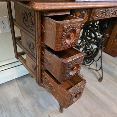 antique Singer treadle sewing machine with a wooden cabinet Complete with accessories and original manual