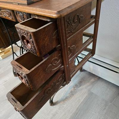 antique Singer treadle sewing machine with a wooden cabinet Complete with accessories and original manual