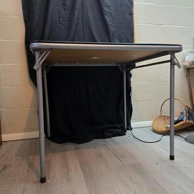 Cosco card table with black top and 4 matching folding chairs