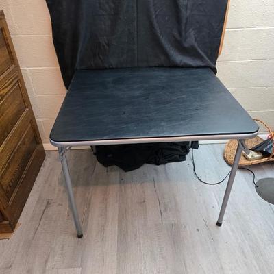 Cosco card table with black top and 4 matching folding chairs