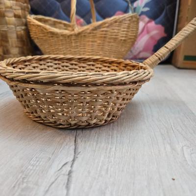 Light colored wicker baskets and a vintage macrame and beaded mirror with a frosted scene