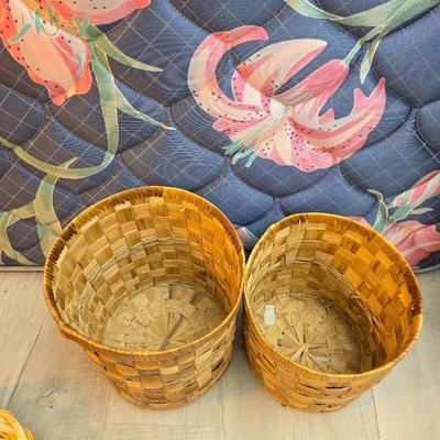 Light colored wicker baskets and a vintage macrame and beaded mirror with a frosted scene