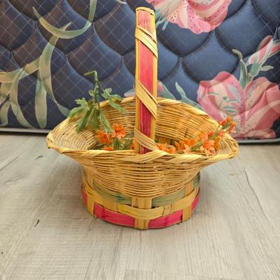 Light colored wicker baskets and a vintage macrame and beaded mirror with a frosted scene