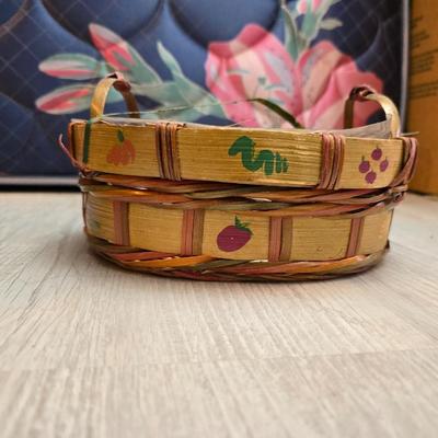 Light colored wicker baskets and a vintage macrame and beaded mirror with a frosted scene