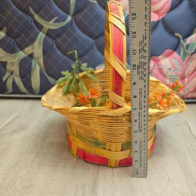 Light colored wicker baskets and a vintage macrame and beaded mirror with a frosted scene