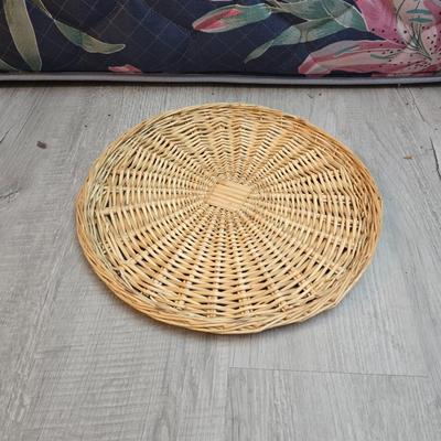 Light colored wicker baskets and a vintage macrame and beaded mirror with a frosted scene