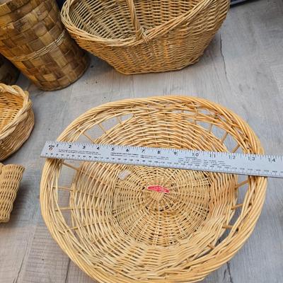 Light colored wicker baskets and a vintage macrame and beaded mirror with a frosted scene