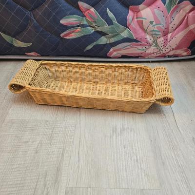 Light colored wicker baskets and a vintage macrame and beaded mirror with a frosted scene