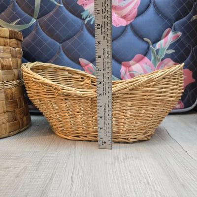 Light colored wicker baskets and a vintage macrame and beaded mirror with a frosted scene