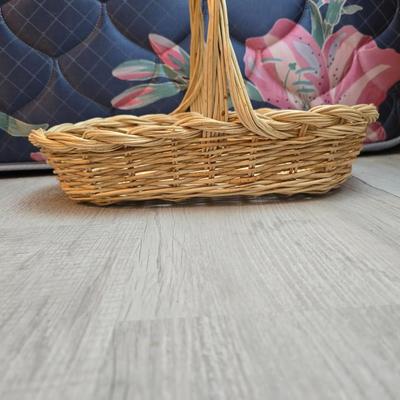 Light colored wicker baskets and a vintage macrame and beaded mirror with a frosted scene