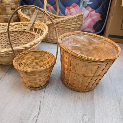 Light colored wicker baskets and a vintage macrame and beaded mirror with a frosted scene