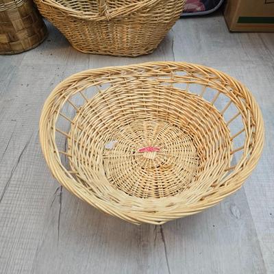 Light colored wicker baskets and a vintage macrame and beaded mirror with a frosted scene