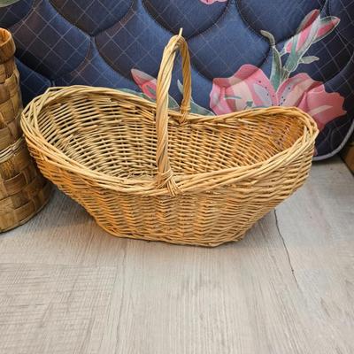Light colored wicker baskets and a vintage macrame and beaded mirror with a frosted scene