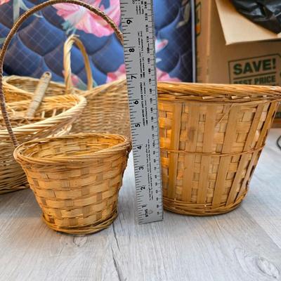 Light colored wicker baskets and a vintage macrame and beaded mirror with a frosted scene