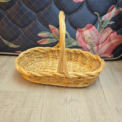 Light colored wicker baskets and a vintage macrame and beaded mirror with a frosted scene