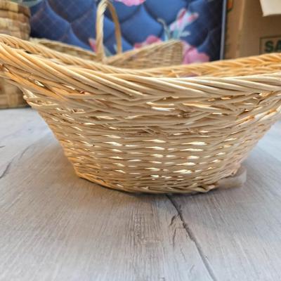 Light colored wicker baskets and a vintage macrame and beaded mirror with a frosted scene