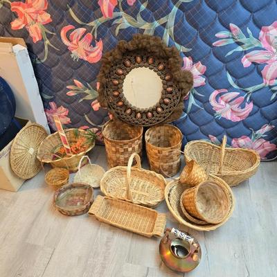 Light colored wicker baskets and a vintage macrame and beaded mirror with a frosted scene