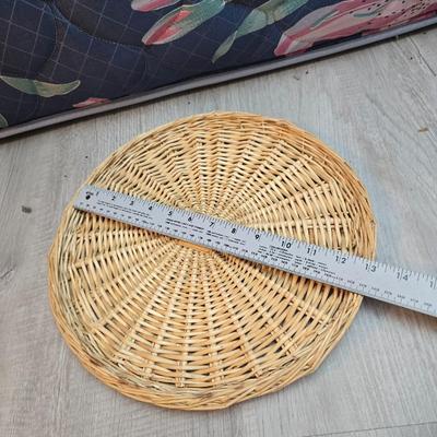 Light colored wicker baskets and a vintage macrame and beaded mirror with a frosted scene