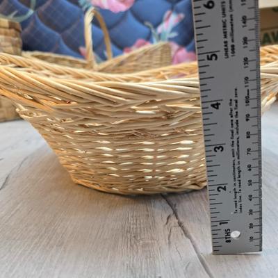 Light colored wicker baskets and a vintage macrame and beaded mirror with a frosted scene