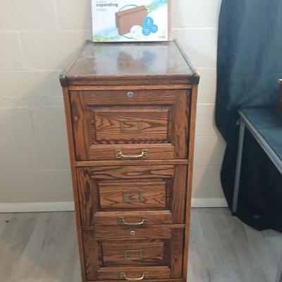 Three drawer wooden filing cabinet with a new 6 pocket expanding wallet