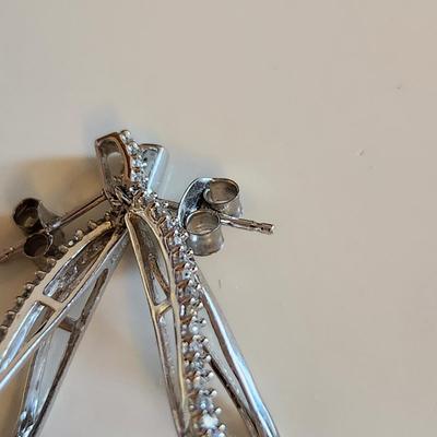 Sale Photo Thumbnail #236: This auction lot is for a Pair of 10K White Gold Diamond Earrings.  These stunning earrings are made with White Gold to enhance the nifty row of chip stones tested as diamonds.  The earrings weight about 2.5 grams by our scale.