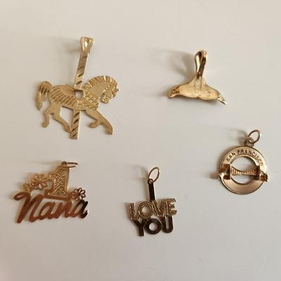 Sale Photo Thumbnail #260: This auction lot is for a Grouping of 14K Gold Charms.  Each of the five charms is marked 14K.  The grouping weighs about 3.6 grams on our scale. Use as the group or gift them out to your family and friends.