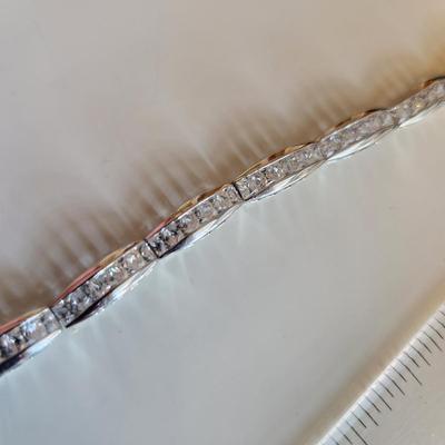 Sale Photo Thumbnail #265: This auction lot is for a Sterling Silver Bracelet.  This fashion bracelet is marked 925. It is decorated with nicely cut glass gems.  See photo for size.