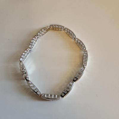 Sale Photo Thumbnail #262: This auction lot is for a Sterling Silver Bracelet.  This fashion bracelet is marked 925. It is decorated with nicely cut glass gems.  See photo for size.