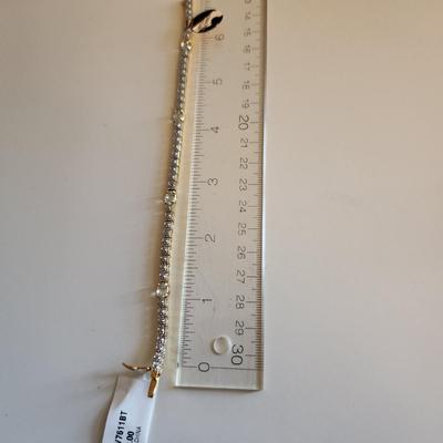 Sale Photo Thumbnail #271: This auction lot is for a Sterling Silver Bracelet.  The bracelet is new and still sports the maker's tags. It is marked 925. The bracelet has for very light blue stones with raised metal sections between each stone. A very handsome item of jewelry.  See 