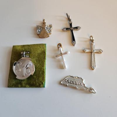 Sale Photo Thumbnail #279: This auction lot is for a Collection of Sterling Silver Charms & Crosses.  This is a fun grouping of small items.  The Sweet 16, Cozumel and pearl cross are not marked but we feel are precious.  The angel is marked 925 and the remaining two crosses are ma
