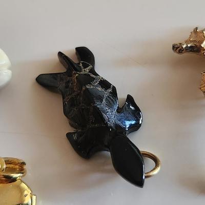 Sale Photo Thumbnail #290: This auction lot is for Four Sweet Charms.  This charms where in the bottom of a small dresser jewelry box in a recent estate. There is a small carved white whale, a carved stone turtle, a sea horse and a gold-tone heart locket in this group.