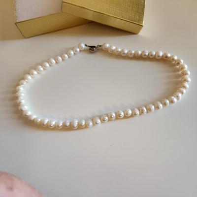 Sale Photo Thumbnail #297: This auction lot is for a Pearl Necklace. This necklace is made with cultured, hand-induced, natural pearls. This is a beautiful set of pearls - just perfect to accompany your little black dress.