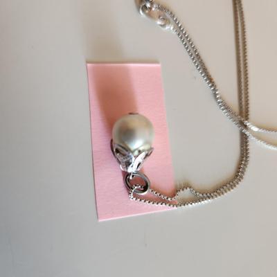 Sale Photo Thumbnail #328: This auction lot is for a Trio of Sterling Silver Jewelry.  This trio consists of a fancy pin with cut glass gems, a pair of sterling earrings with cut glass stones and a very nice 18-inch necklace with a drilled pearl as pendant.  All are marked 925.  Bu