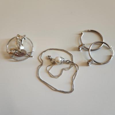 Sale Photo Thumbnail #330: This auction lot is for a Trio of Sterling Silver Jewelry.  This trio consists of a fancy pin with cut glass gems, a pair of sterling earrings with cut glass stones and a very nice 18-inch necklace with a drilled pearl as pendant.  All are marked 925.  Bu