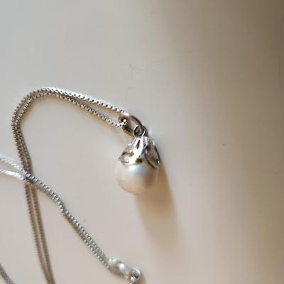 Sale Photo Thumbnail #327: This auction lot is for a Trio of Sterling Silver Jewelry.  This trio consists of a fancy pin with cut glass gems, a pair of sterling earrings with cut glass stones and a very nice 18-inch necklace with a drilled pearl as pendant.  All are marked 925.  Bu