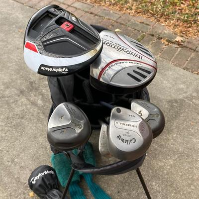 LOT 33: Collection of Golf Clubs and Accessories - Taylor Made, Callaway, Ram, Vesuvius Ceramic Putter with Ogio Golf Bag