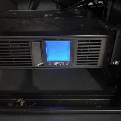 LOT 148: Pure Sign Tripp Light Uninterruptible SMART1500LCD 1500VA Rack Mount UPS Battery Backup, 900W, in cooling rack
