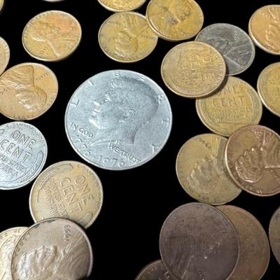Sale Photo Thumbnail #763: Includes 58 Lincoln cents from the 1920s to the 1950s, two Kennedy half dollars, and two flattened (souvenir) pennies. Total of 62 pieces. [RM]