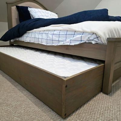 Sale Photo Thumbnail #308: Twin trundle bed # .with mattresses. Driftwood color with natural colored upholstered headboard. SHEETS AND BEDDING (comforter, pillow, sham, sheets, & blanket) ARE NOT INCLUDED, The nightstand you see in the photograph is also NOT included. Note that the