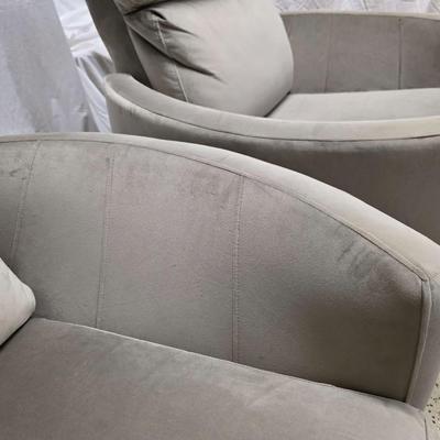 Sale Photo Thumbnail #334: Pair of modern gray microsuede swivel recliners. The recliners have curved armrests, and the light gray velvety fabric feels very elegant.  Each recliner has minor blemishes; most seem superficial dirty spots that could be easily cleaned, but please zoom 